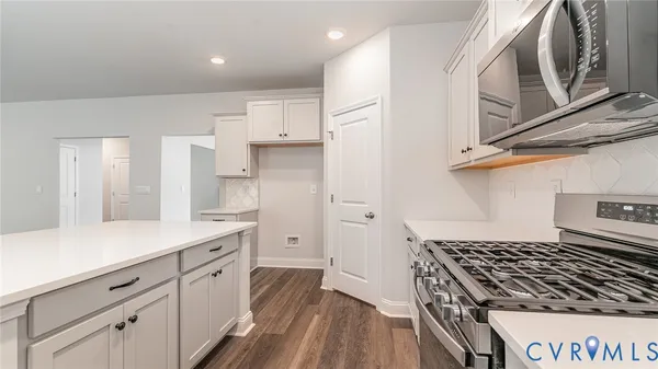 a kitchen with cabinets and a stove
