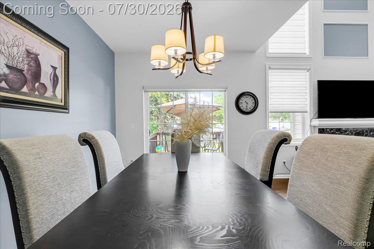 41447 Glade Road Canton, MI 48187 - Photo 13 of 28 Dining area with a black wood-finish table, upholstered chairs, and a sliding glass door providing exterior access