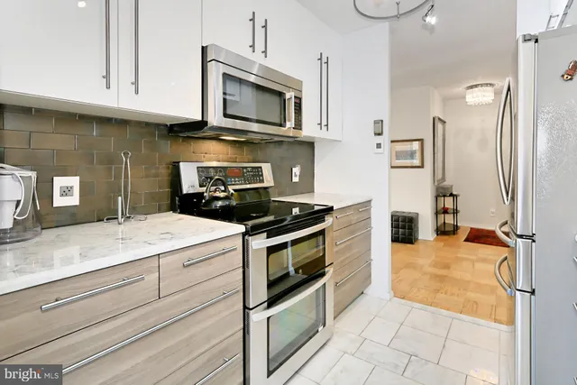 a kitchen with cabinets and window