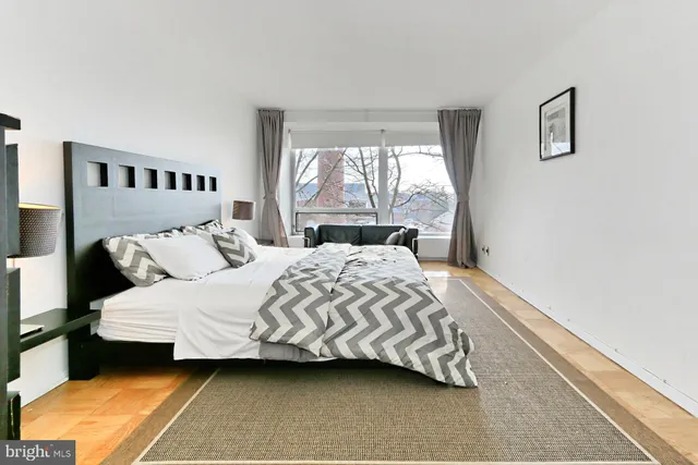 a living room with a large window and outer view