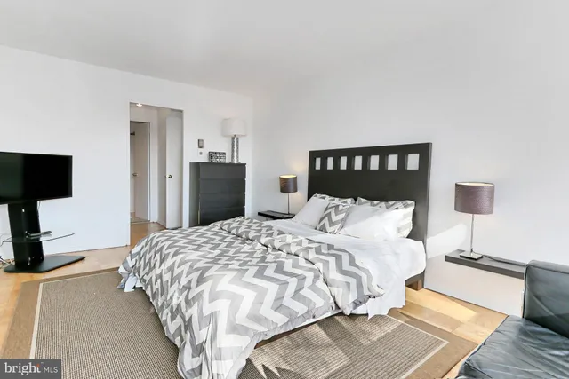 a bedroom with a bed and a flat screen tv