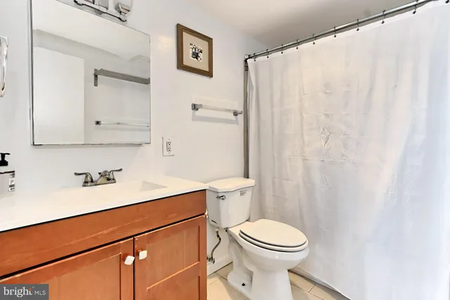 a living room with furniture a rug and a table