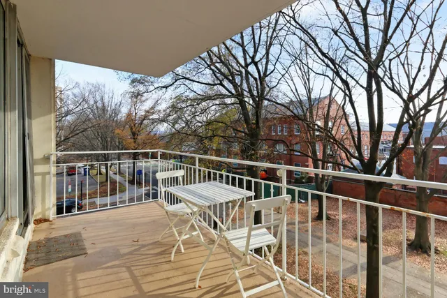 a street sign on a sidewalk next to a road