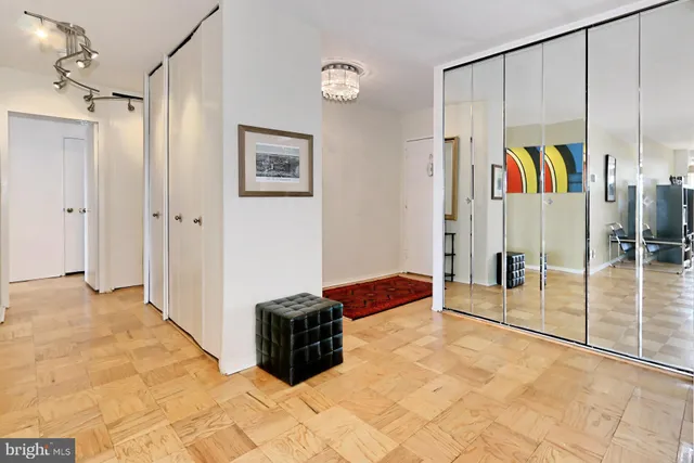 a living room with furniture a table and a large window
