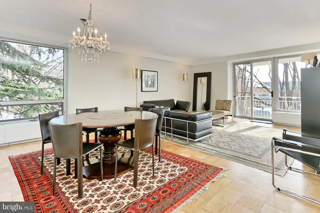 a living room with furniture and a floor to ceiling window