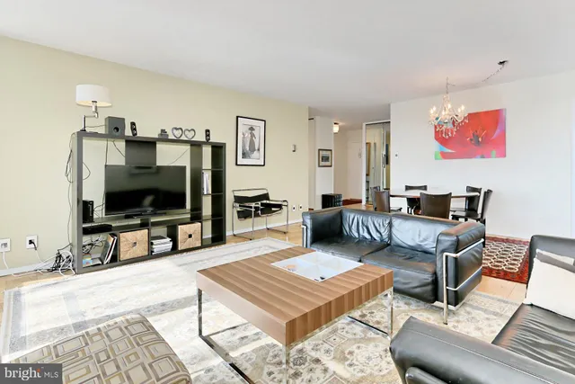 a living room with furniture a rug and a window