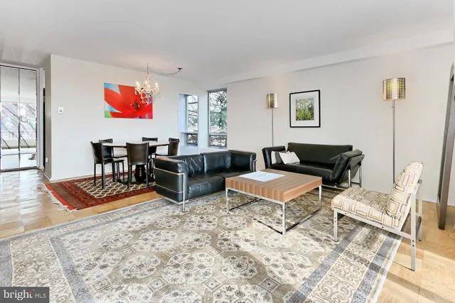 a dining room with furniture a rug and a chandelier