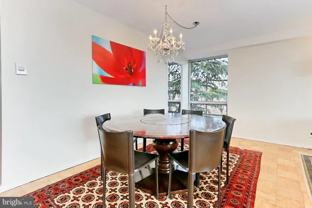 a view of a dining room with furniture and chandelier