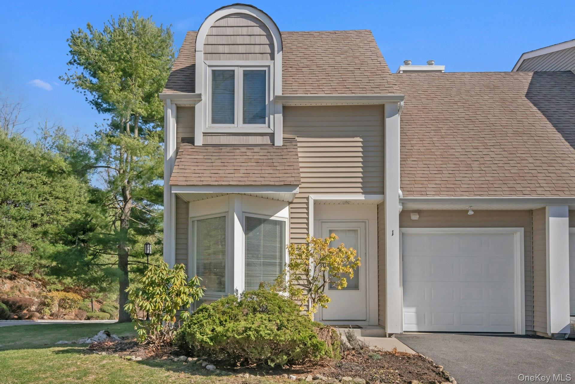 1 Spring Pond Drive, Unit 1 Ossining, NY 10562 - Photo 2 of 34 a front view of a house with garden