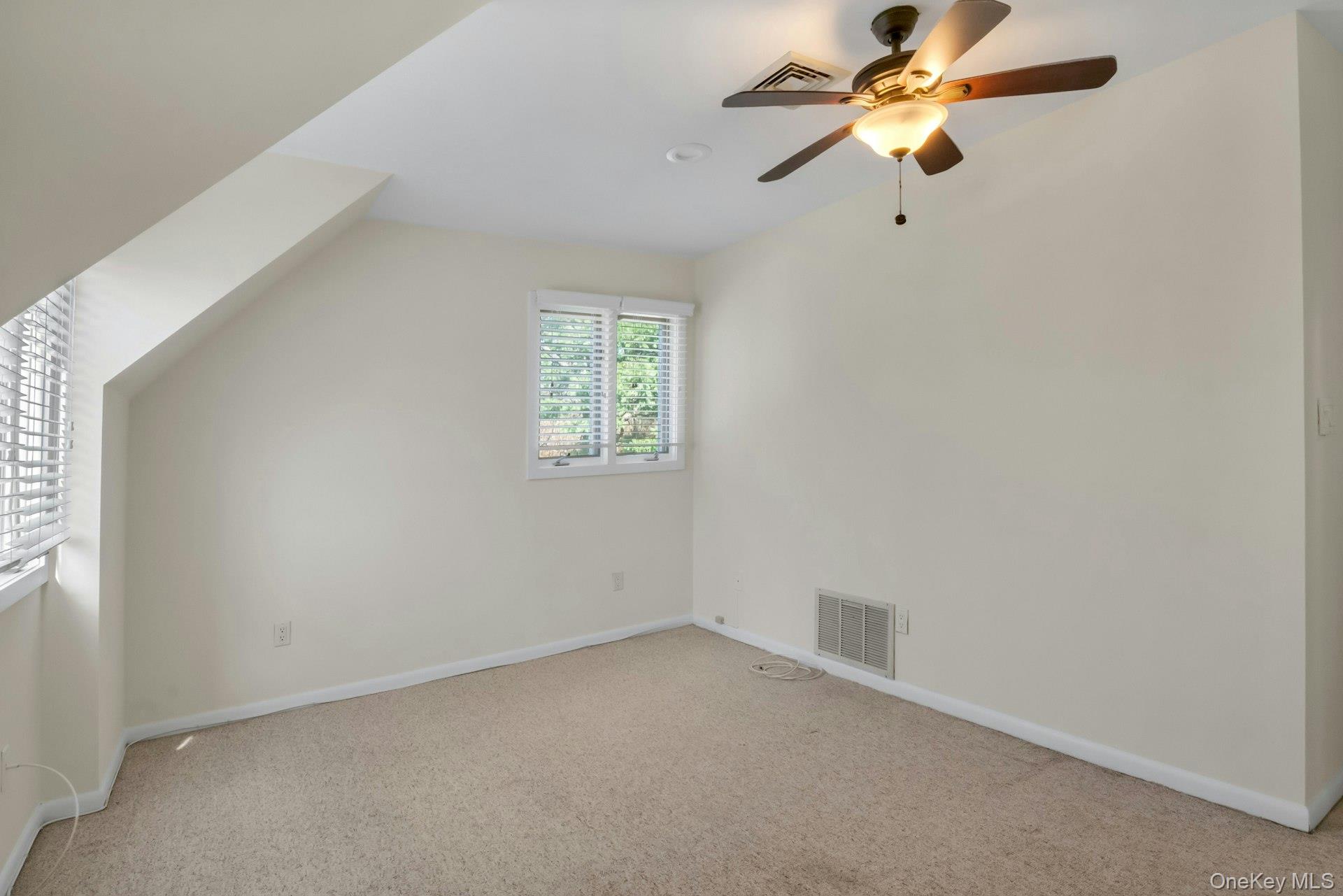 1 Spring Pond Drive, Unit 1 Ossining, NY 10562 - Photo 23 of 34 an empty room with a window and a fan