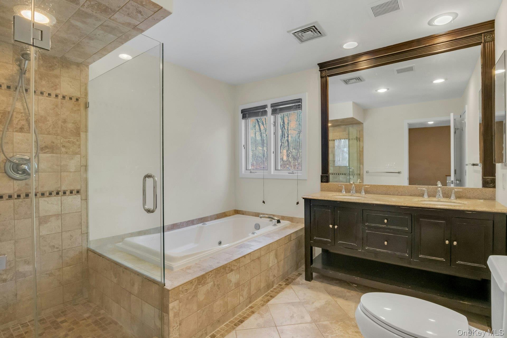 1 Spring Pond Drive, Unit 1 Ossining, NY 10562 - Photo 27 of 34 a bathroom with a bathtub shower sink mirror and toilet