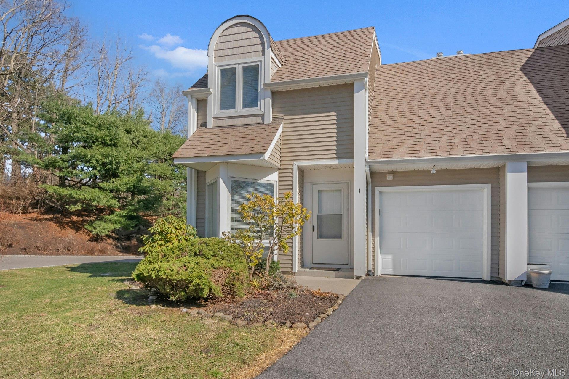 1 Spring Pond Drive, Unit 1 Ossining, NY 10562 - Photo 3 of 34 a front view of a house with garden