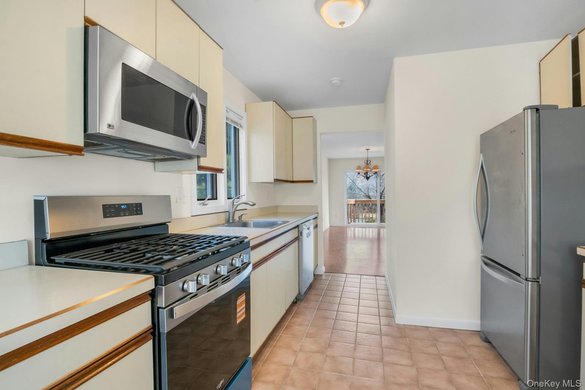 1 Spring Pond Drive, Unit 1 Ossining, NY 10562 - Photo 7 of 34 a kitchen with stainless steel appliances a refrigerator stove and microwave