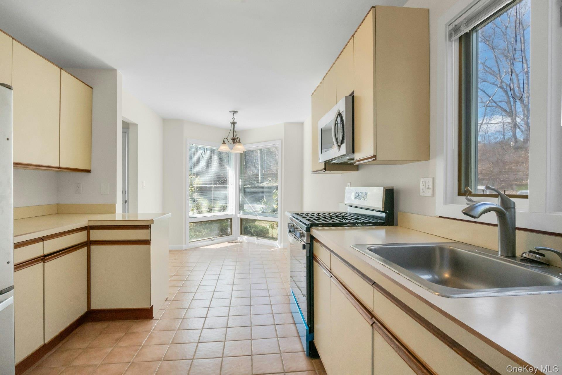 1 Spring Pond Drive, Unit 1 Ossining, NY 10562 - Photo 8 of 34 a kitchen with a sink stove and cabinets