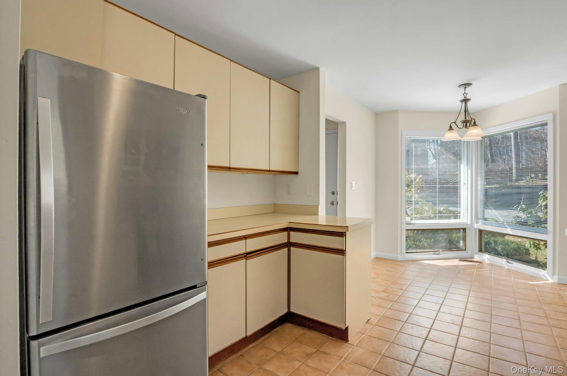 1 Spring Pond Drive, Unit 1 Ossining, NY 10562 - Photo 9 of 34 a kitchen with stainless steel appliances a refrigerator and a sink