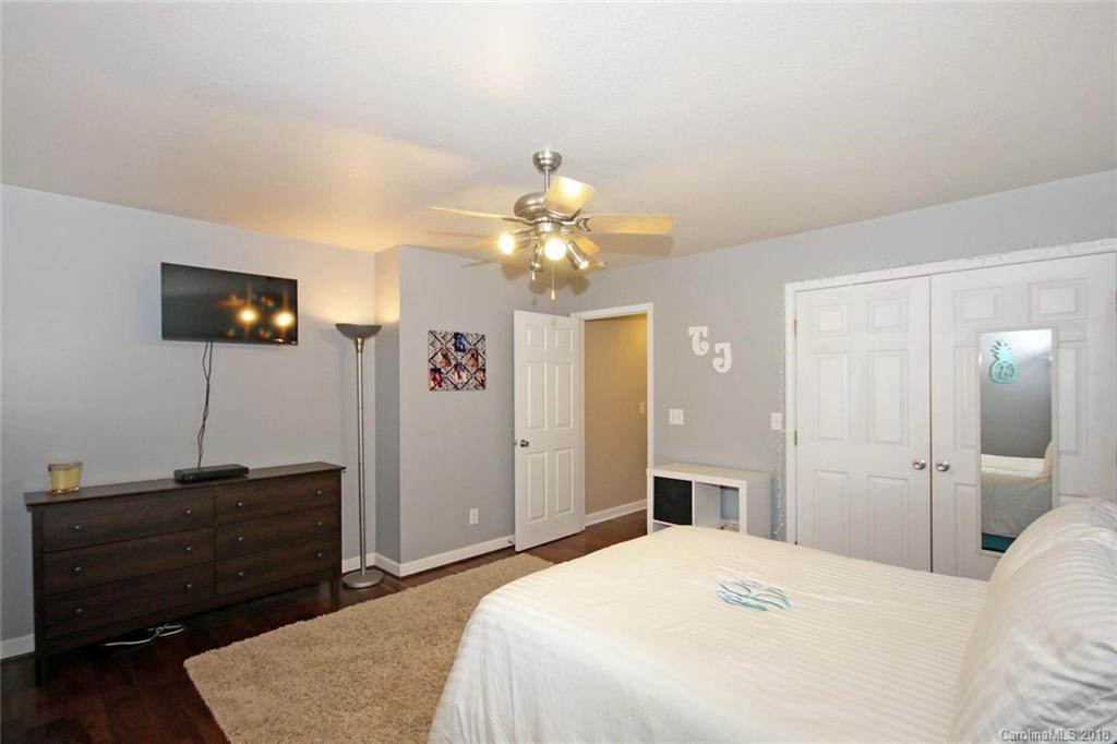 621 Adrian Road Salisbury, NC 28146 - Photo 22 of 36 a bedroom with a bed and a flat tv screen on dresser