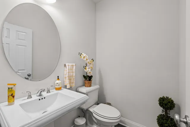a bathroom with a sink mirror vanity and toilet