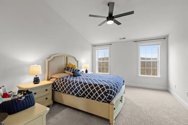 a bedroom with a bed dresser and a window