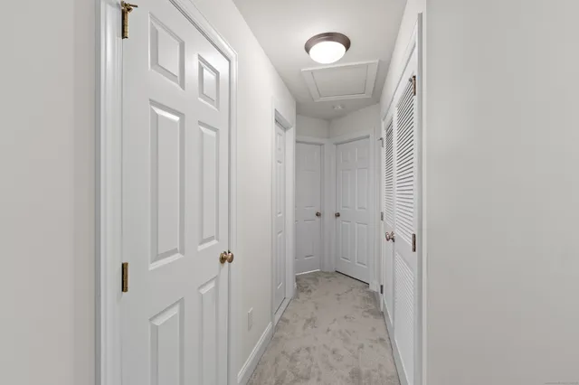 a view of a hallway with wooden floor and entryway