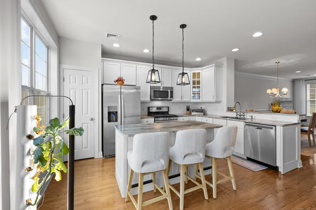 a large kitchen with a table and chairs