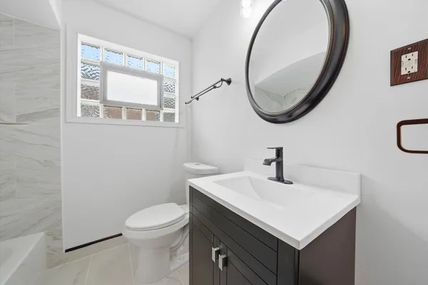 a bathroom with a sink a mirror and a toilet