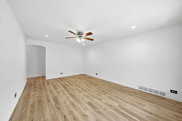 a view of a room with wooden floor and white walls