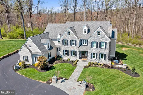 a front view of a house with a yard table and chairs