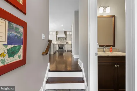 a bathroom with a granite countertop sink mirror and a bathtub