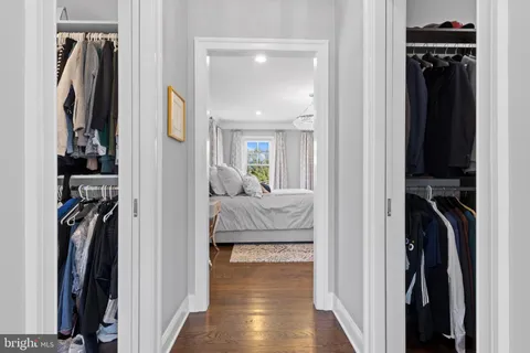 a spacious bathroom with a granite countertop sink a toilet a mirror and shower