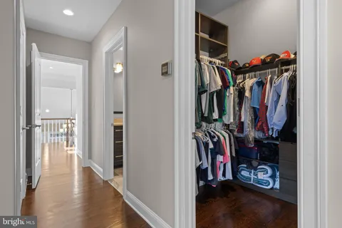 a bathroom with a granite countertop sink a toilet and a mirror