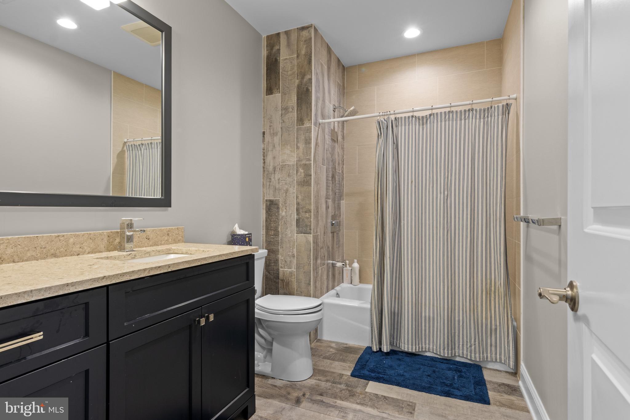 2207 White Horse Road Berwyn, PA 19312 - Photo 46 of 69 a spacious bathroom with a granite countertop sink a toilet a mirror and shower