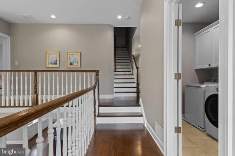 a front view of a house with garden and sitting area