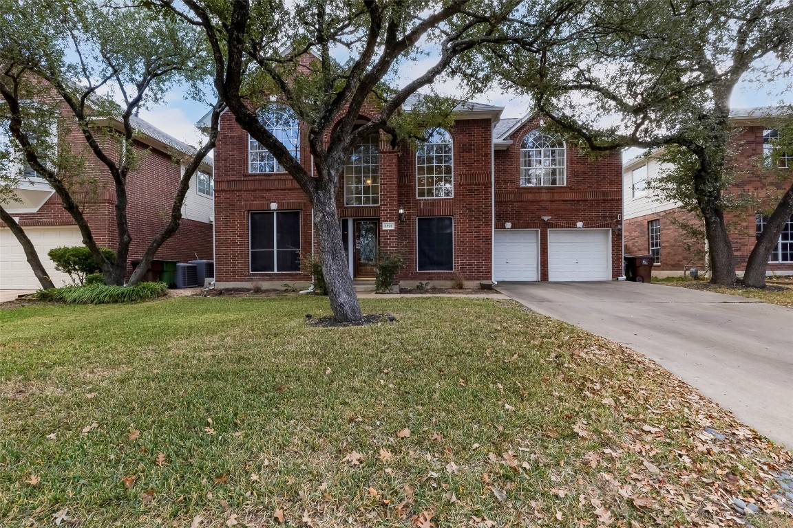 a front view of house with a garden