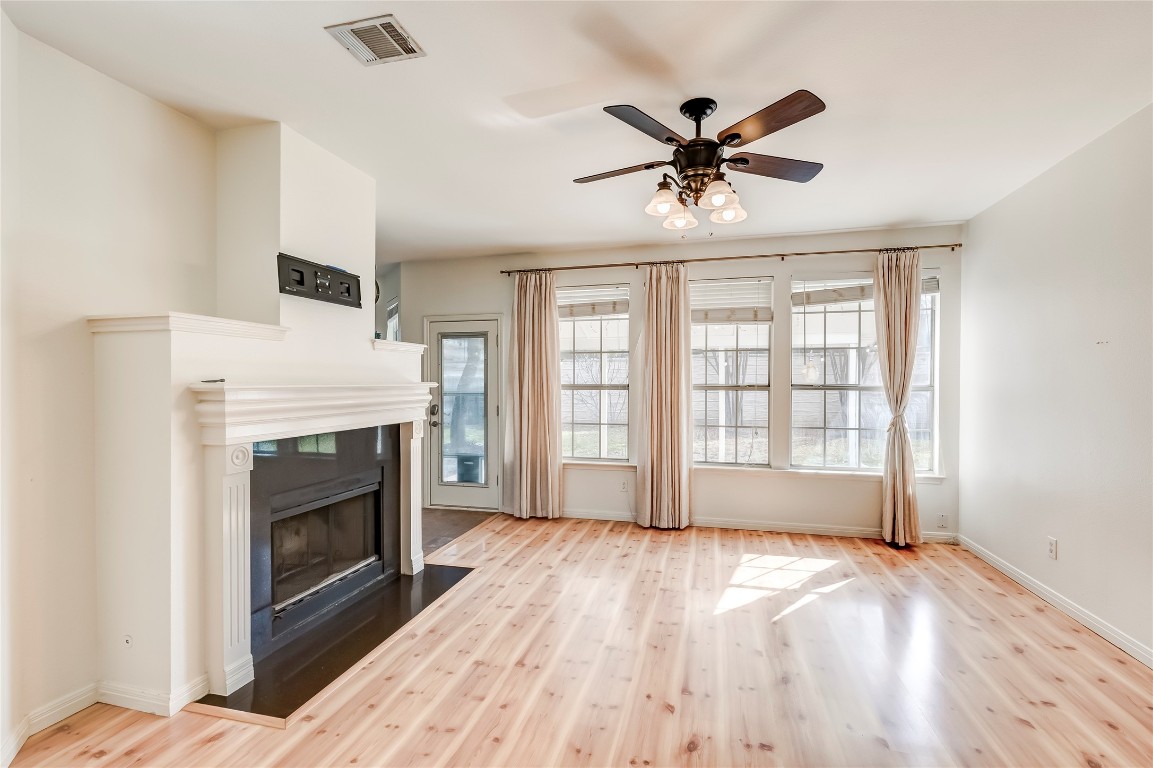 1901 Springwater Drive Round Rock, TX 78681 - Photo 11 of 36 a view of empty room with wooden floor and fireplace