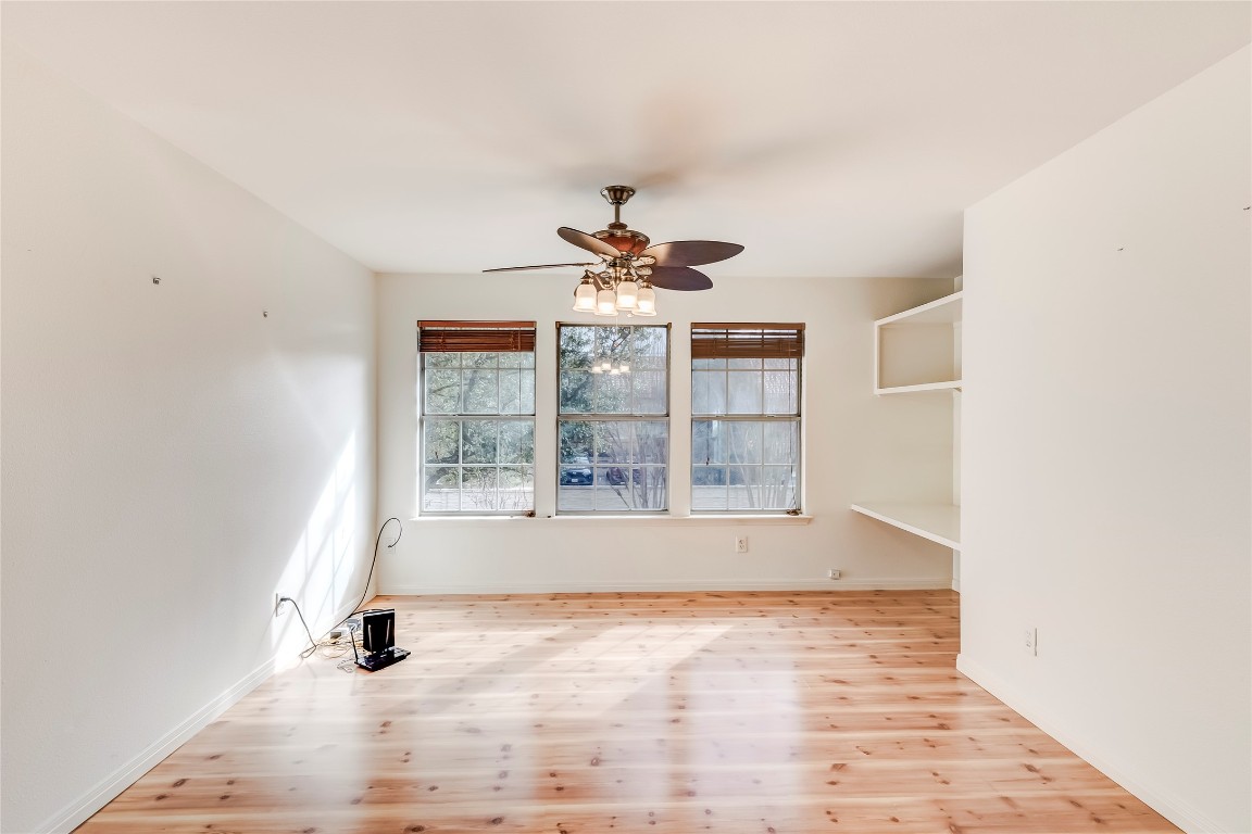 1901 Springwater Drive Round Rock, TX 78681 - Photo 18 of 36 wooden floor in an empty room with a window