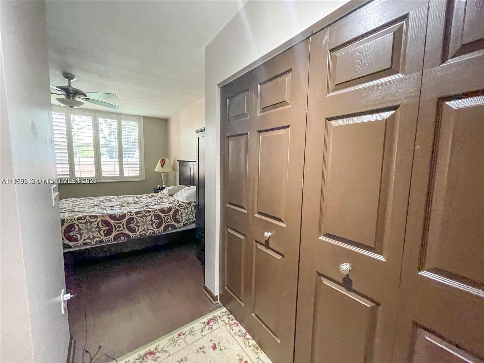 3153 Clint Moore Road, Unit 106 Boca Raton, FL 33496 - Photo 21 of 38 a bedroom with a bed and a window