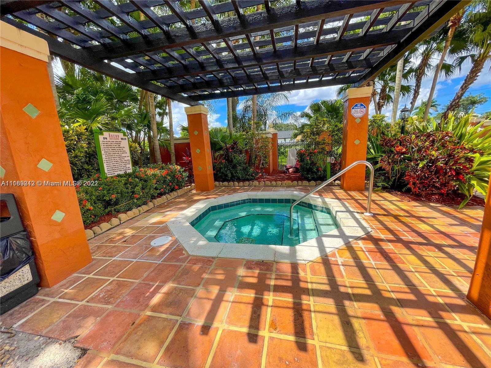 3153 Clint Moore Road, Unit 106 Boca Raton, FL 33496 - Photo 23 of 38 a view of a swimming pool with a porch