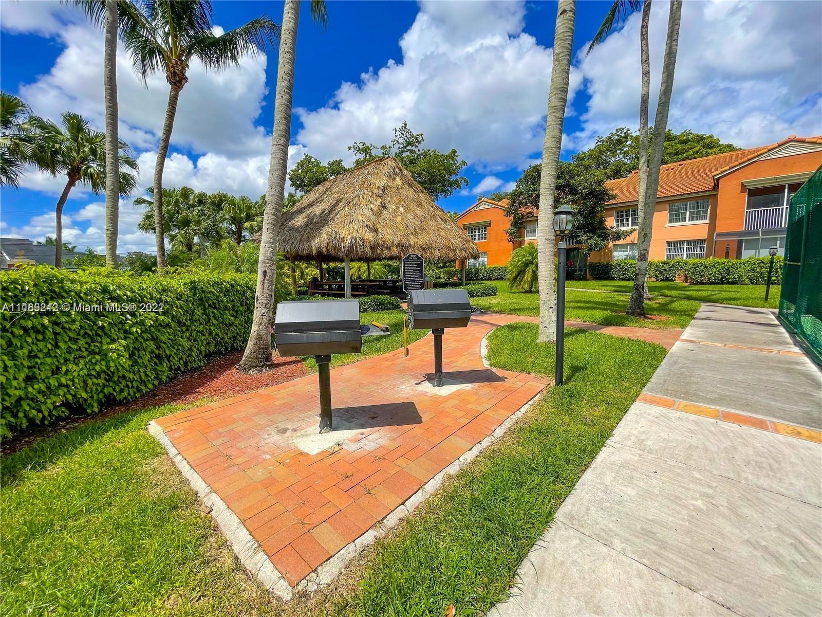 3153 Clint Moore Road, Unit 106 Boca Raton, FL 33496 - Photo 26 of 38 a view of a park with plants and palm trees