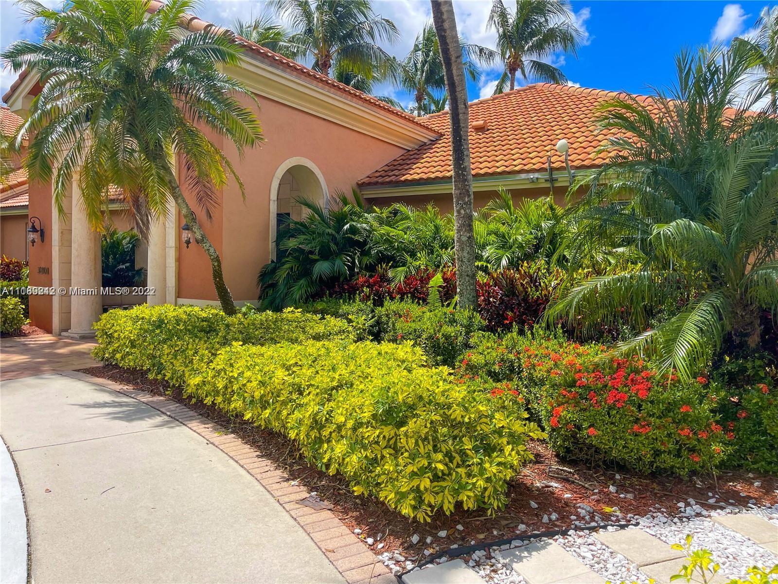 3153 Clint Moore Road, Unit 106 Boca Raton, FL 33496 - Photo 30 of 38 a front view of a house with a yard and garden
