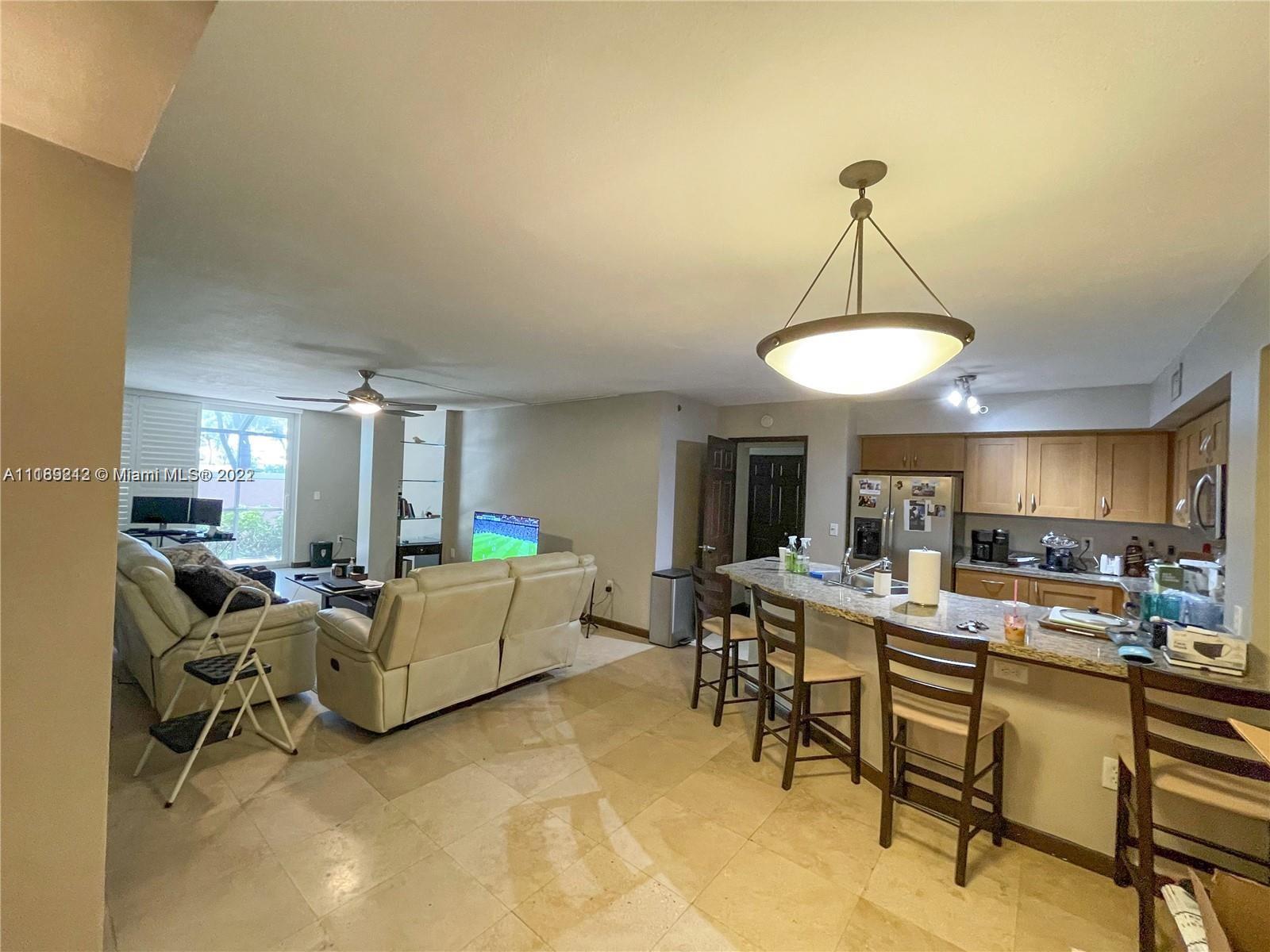 3153 Clint Moore Road, Unit 106 Boca Raton, FL 33496 - Photo 3 of 38 a living room with furniture and a wooden floor
