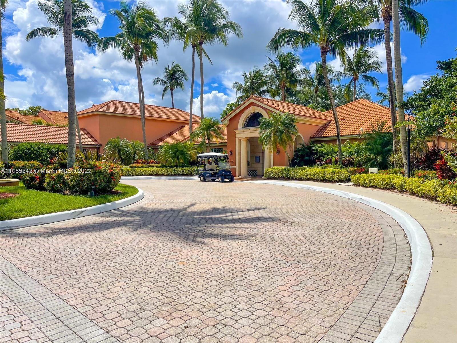 3153 Clint Moore Road, Unit 106 Boca Raton, FL 33496 - Photo 32 of 38 a view of a white house with a yard and palm trees