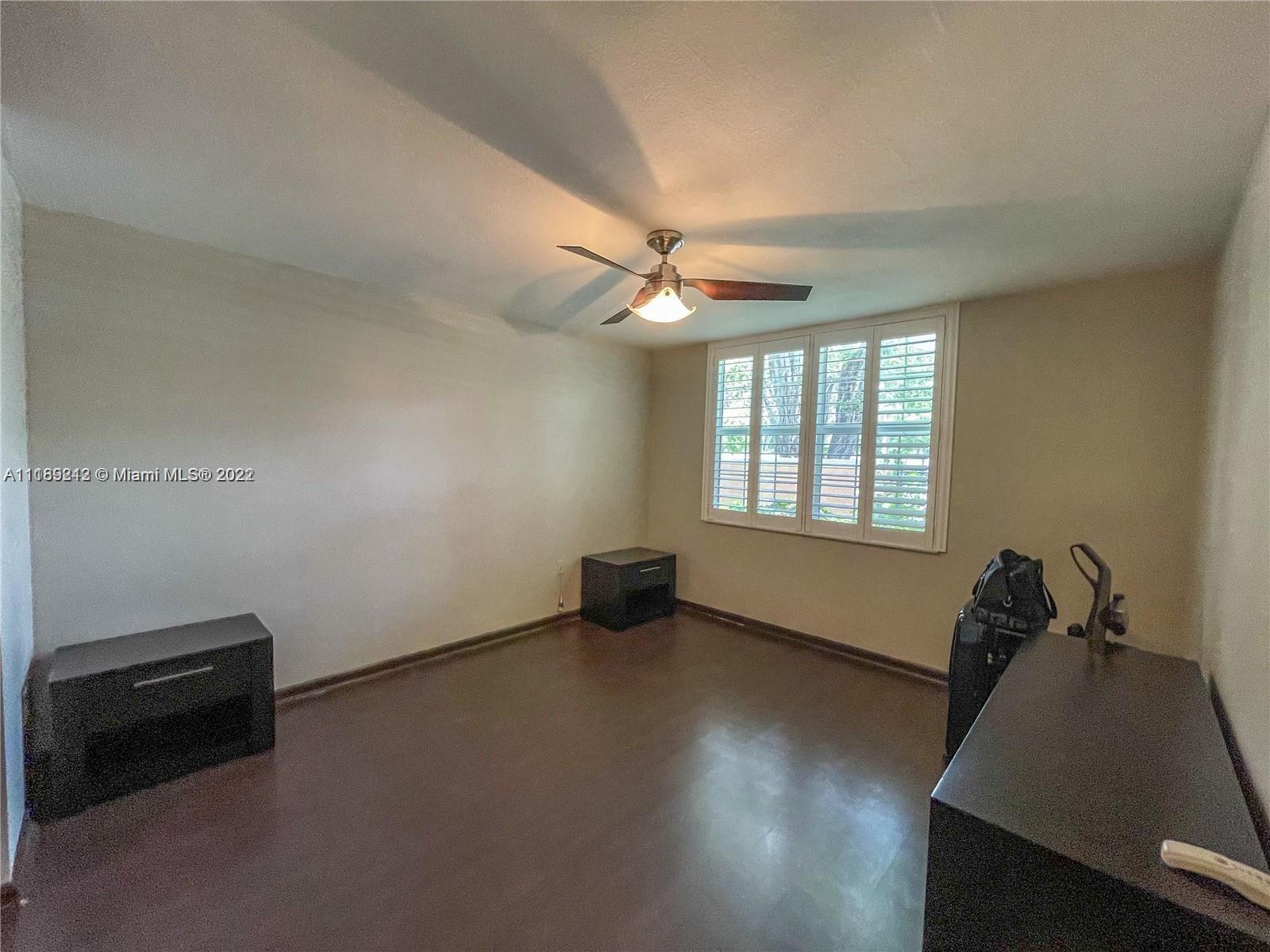 3153 Clint Moore Road, Unit 106 Boca Raton, FL 33496 - Photo 35 of 38 an empty room with windows and ceiling fan