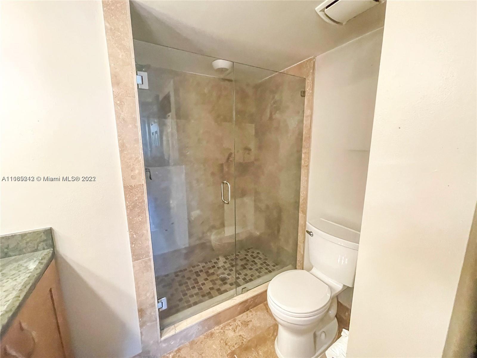 3153 Clint Moore Road, Unit 106 Boca Raton, FL 33496 - Photo 36 of 38 a bathroom with a toilet and a shower