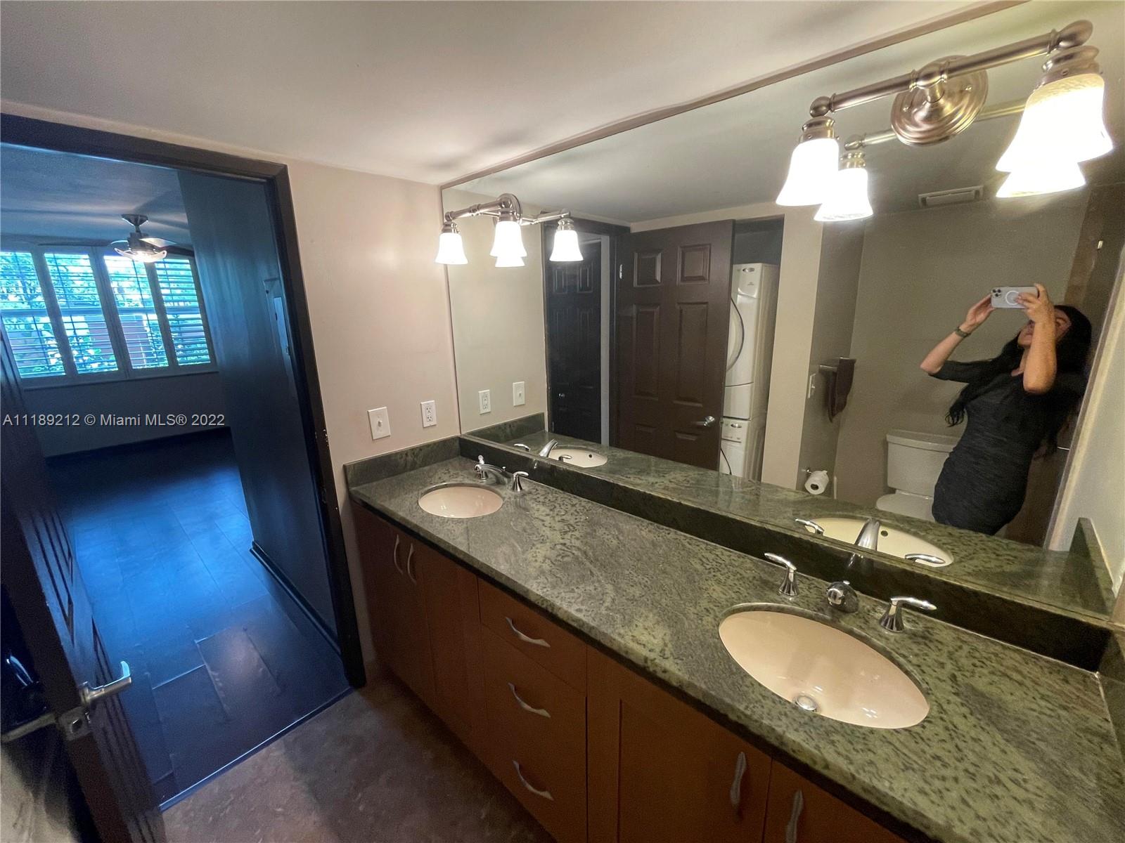 3153 Clint Moore Road, Unit 106 Boca Raton, FL 33496 - Photo 37 of 38 a bathroom with a double vanity sink and a mirror