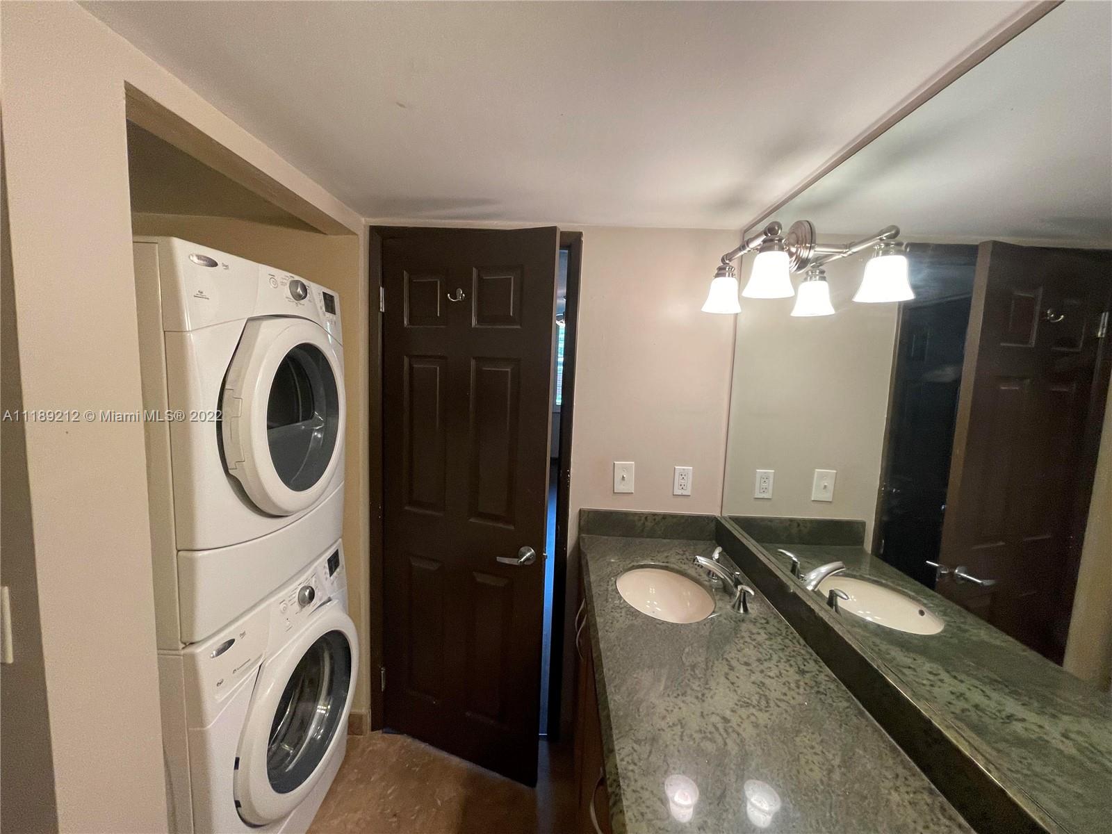 3153 Clint Moore Road, Unit 106 Boca Raton, FL 33496 - Photo 5 of 38 a bathroom with a double vanity sink and a mirror