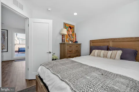 a bed room with a bed and dresser