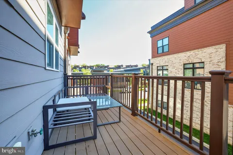 a view of balcony with wooden floor and fence
