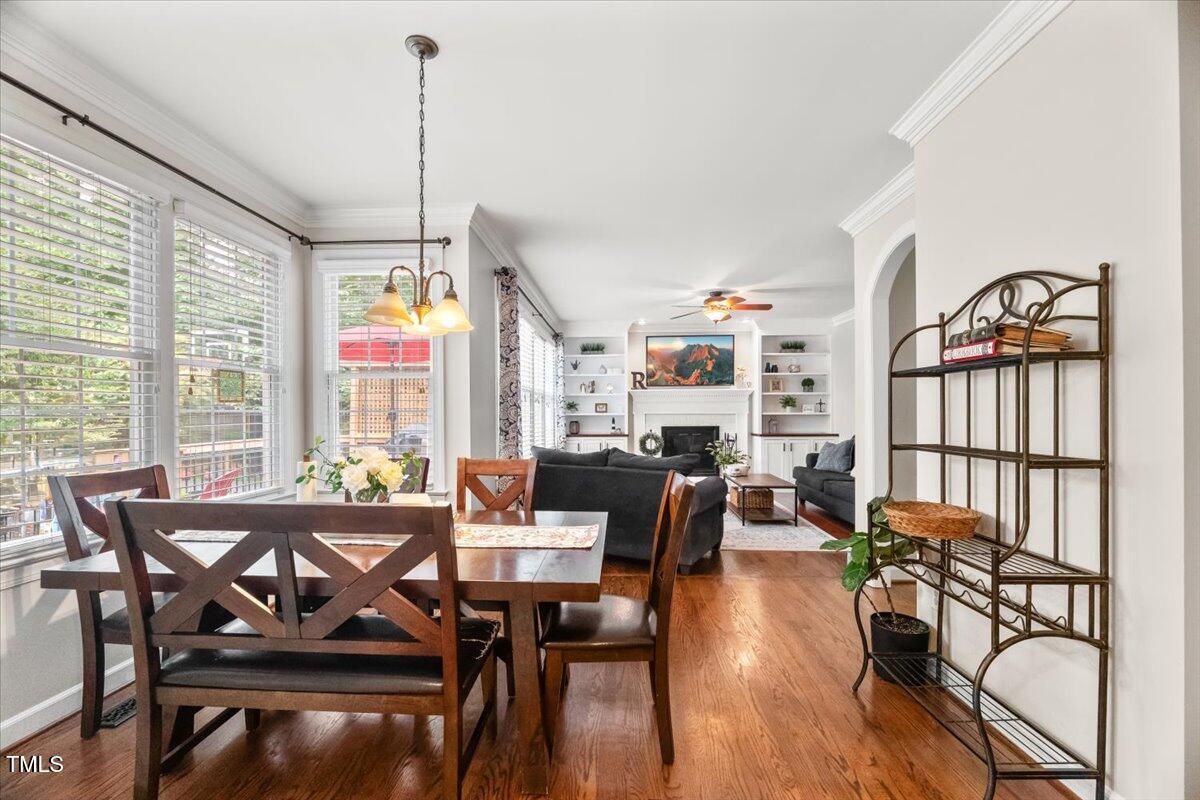 102 Barometer Lane Cary, NC 27513 - Photo 10 of 44 a dining room with wooden floor furniture and a floor to ceiling window