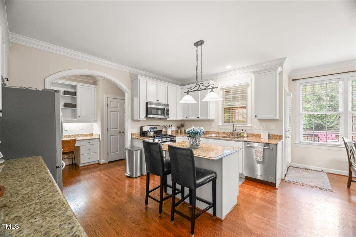 102 Barometer Lane Cary, NC 27513 - Photo 12 of 44 a kitchen with a table chairs refrigerator and cabinets