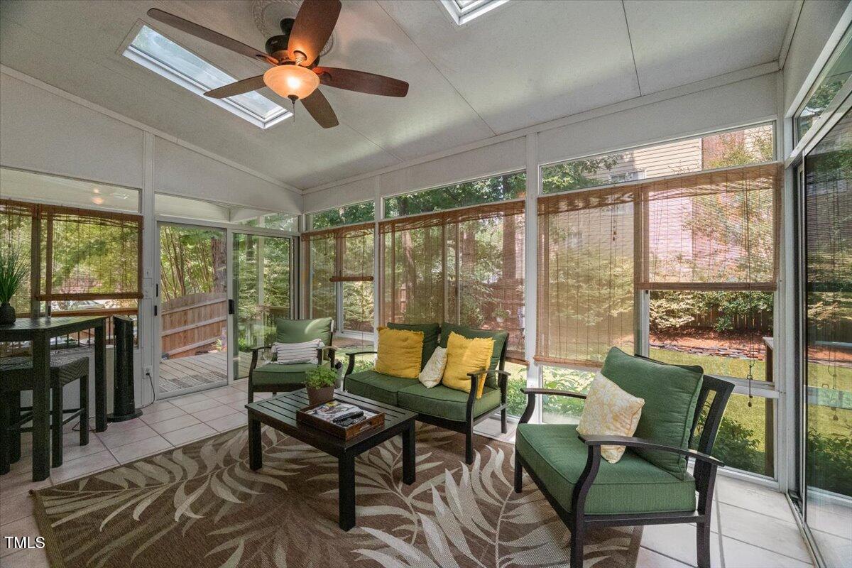 102 Barometer Lane Cary, NC 27513 - Photo 14 of 44 a living room with furniture a ceiling fan and a floor to ceiling window